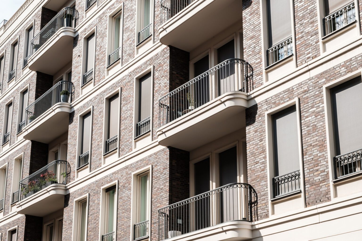 close up photo of apartment building showing balcony and windows
