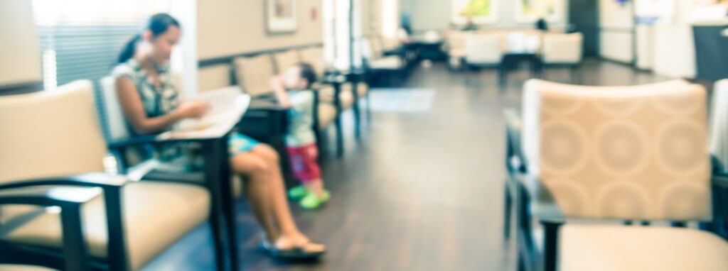 Blurred image of woman and child in waiting room