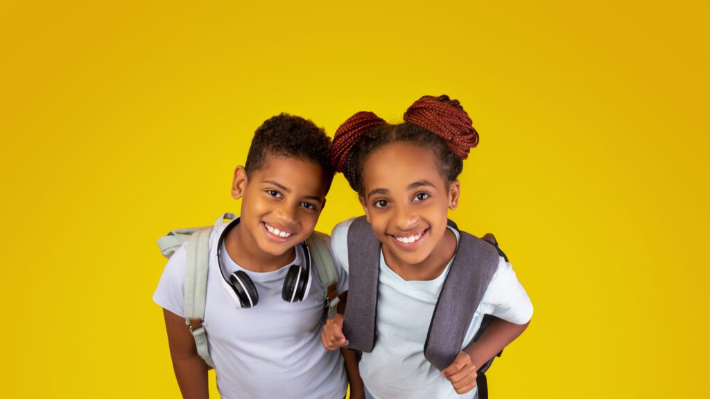 Cheerful school-age children smiling at the camera